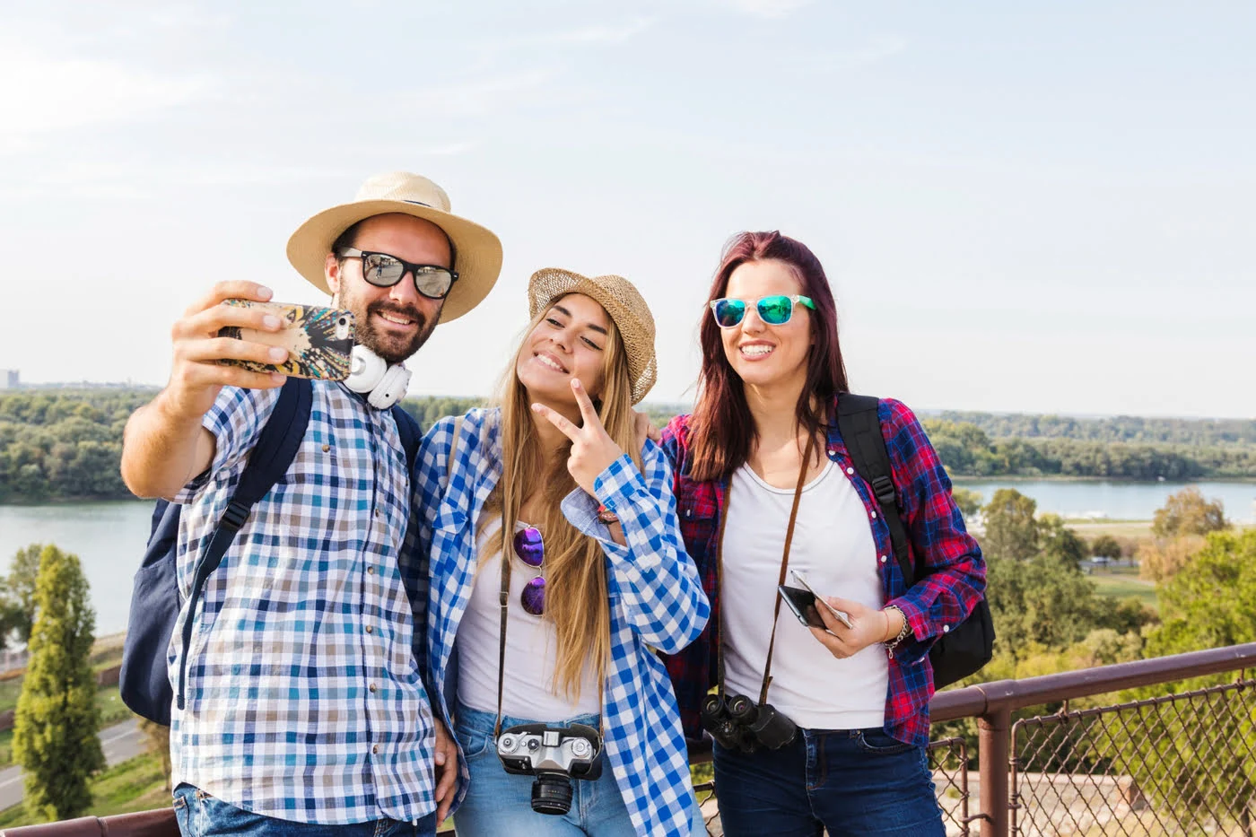Group of male and female hikers taking selfie on mobile phone